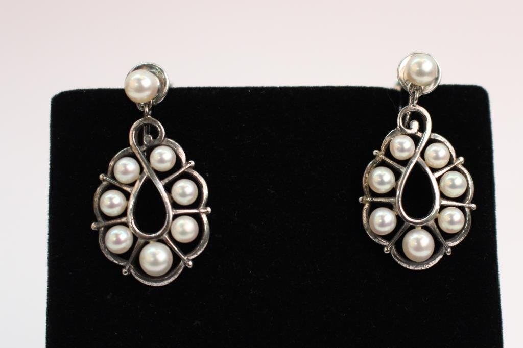 Pair of Antique Mikimoto Drop Pearl Earrings: A pair of Antique Mikimoto pearl earrings each with eight 3.3mm-4.3mm pearls, set in silver screw back mounting, 3.6dwt, approximately 1" long