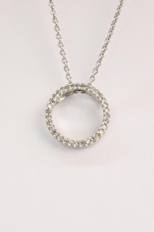 14K White Gold Diamond Circle Pendant, Chain: A 14K white gold circle pendant with thirty-three round diamonds equaling .25ctw, on 16" 14K white gold chain, 1.6dwt