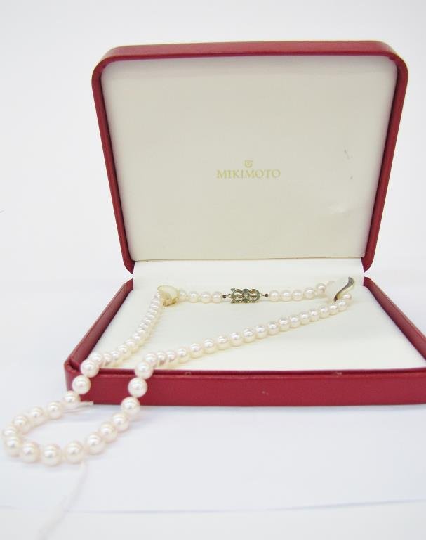 Lady's 18" Strand of Mikimoto Cultured Pearls: A lady's 18" strand of Mikimoto cultured pearls measuring 6.5-7.0mm in diameter, of "A+" quality, with 18K yellow gold clasp