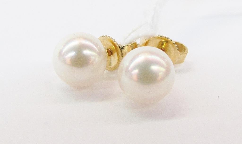 Pair of 18K Yellow Gold Mikimoto Pearl Earrings: A pair of Mikimoto pearl earrings, each with single 7mm pearl, on 18K yellow gold post