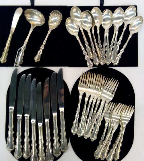 International Sterling Angelique Flatware: A set of International sterling silver flatware, Angelique pattern, including 8 table knives, 8 dinner forks, 8 salad forks, 12 tea spoons, sugar shell, sauce ladle, butter knife