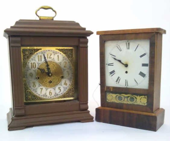 Two Shelf Clocks: A lot of two shelf clocks, including west German clock with rod chime, and an antique clock with tin face, 15" and 12" h