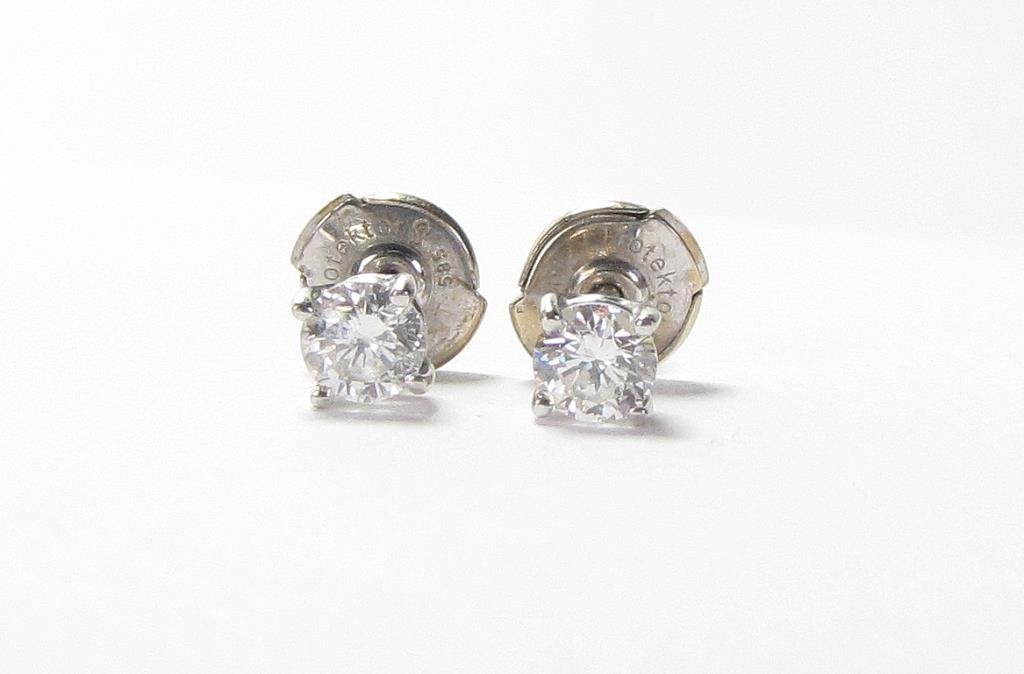 14K White Gold Mounted Diamond Stud Earrings: A pair of 14K white gold mounted diamond stud earrings, .45ctw, with Lapousette backs, .60dwt