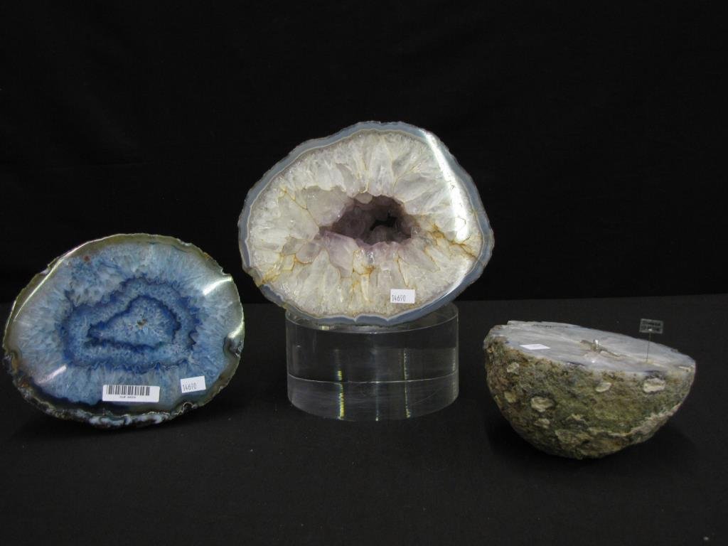 Group of Carved Crystal Geodes: Group of Carved Crystal Geodes including a polished Brazilian blue quartz wafer, polished amethyst and clear quartz wafer and a polished 1/2 cut clear crystal geode with figure and "Danger Thin Ice" s