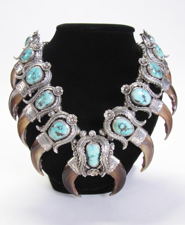 Southwest Silver J.J. Bear Claw Squash Blossom: A Southwest silver squash blossom necklace, marked J.J., approximately 25" long, with eleven irregularly shaped oblong turquoise, twelve coral enhanced claws, floral adornments, approximately 2.25" di