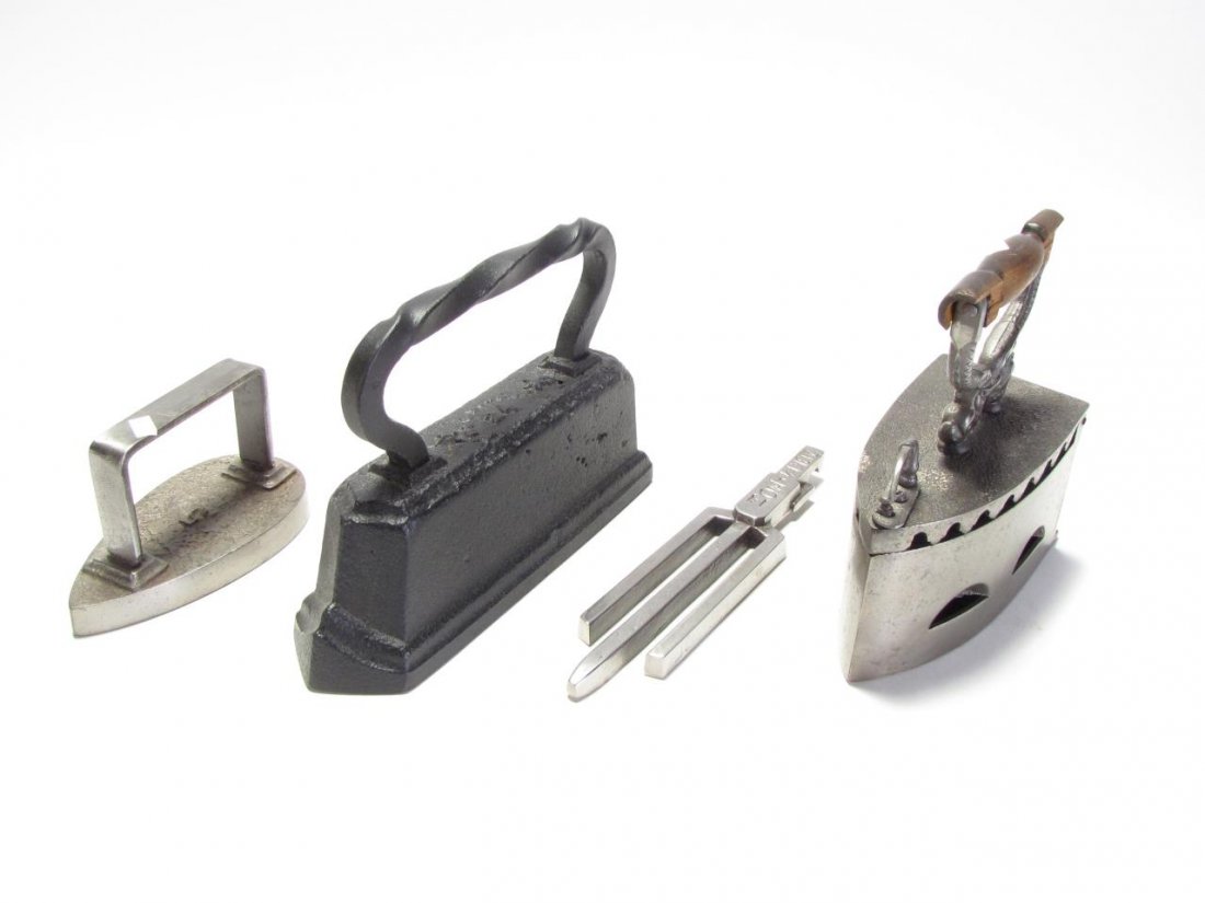 Group of Antique Cast Iron Items: A group of antique accessory items, including cast iron sad irons (large and small), hinged lid ember iron, wall plaque, scale, grate handle