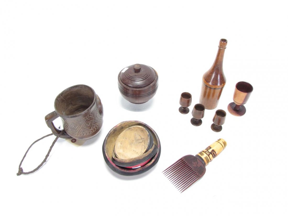 Group of African Decorative Accessories: A group of African decorative objects, including lidded bowl, handled pitcher with carved mask decoration, 3 painted lids, carved Ivory Coast curry brush, wine bottle and four stems