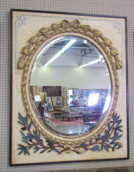 Charles Pollock Reproductions Wall Mirror: A Charles Pollock Reproductions wall mirror, with painted and parcel gilt frame having bowknot and olive branch carvings, oval beveled glass, 58x47