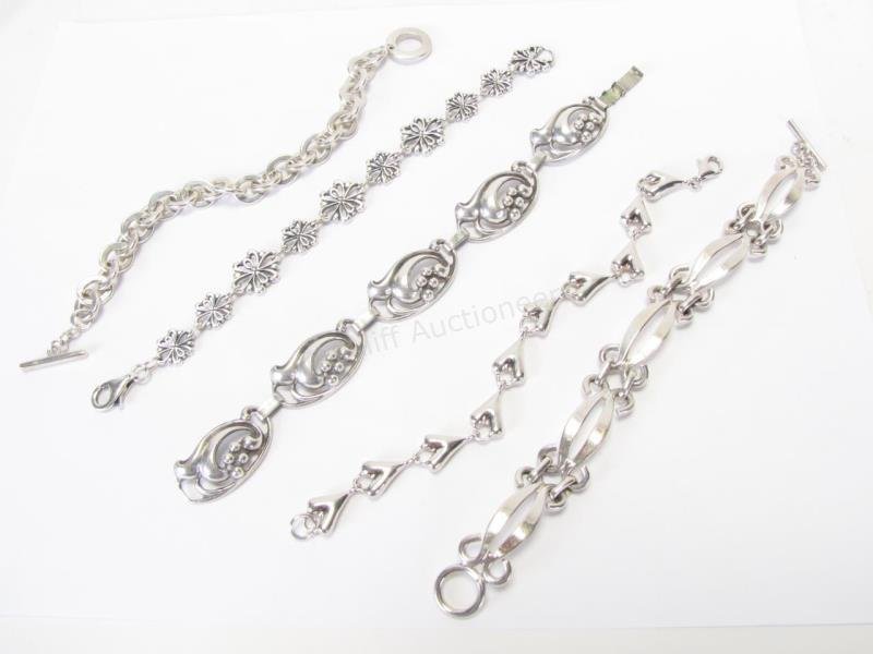 Group of Sterling Silver Bracelets: Five sterling silver link bracelets, each approximately 7" long, in various styles, 82dwt total
