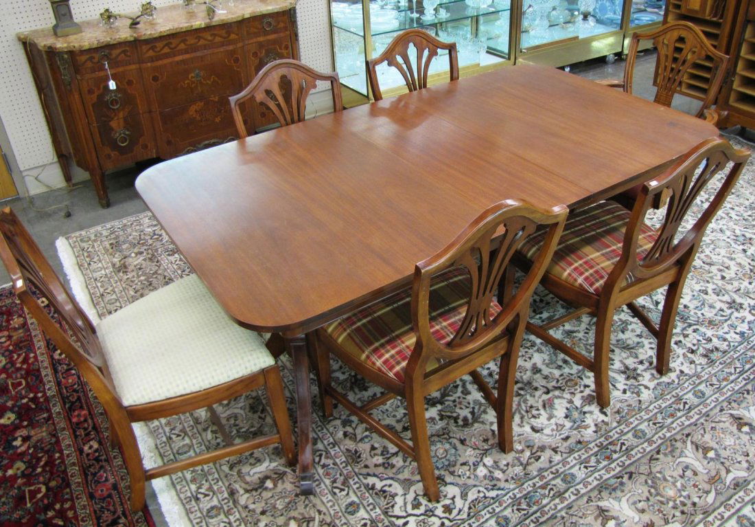 Period-Style Drexel Dining Room Group: A mahogany dining room group, including a Drexel Duncan Phyfe style double pedestal dining table, 60x40x30"h, with a 12" leaf, table pads, and with six Sheraton period style chairs, including one host