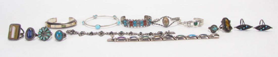 Southwestern Style Jewelry: A large group of Southwestern style jewelry, most unmarked, three pieces marked sterling, including four cuff bracelets (two marked sterling), one bangle bracelet, two link bracelets (one marked sterl