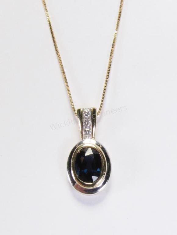 14K Yellow Gold Sapphire Pendant and Chain: A 14K yellow gold pendant with oval bezel set sapphire, diamond accents in bail, on an 18" 14K yellow gold chain