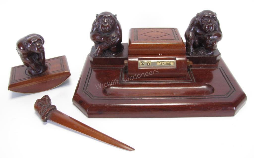 Wood Carved Figural Desk Set: Wood Carved Figural Desk Set, two carved monkey figures flank a lidded ink well with pen holder, mirrored lid, wooden knobs adjust the day and month selector, monkey head letter opener and carved monk