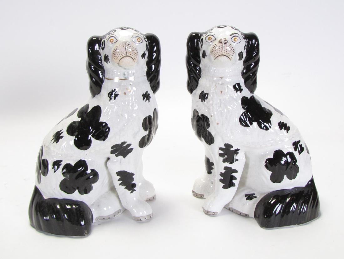 Pair of Staffordshire Porcelain Dogs: Pair of Staffordshire Porcelain Dogs, both with unique free front led design, black and white decoration, unsigned, 8" x 5" x 10" high