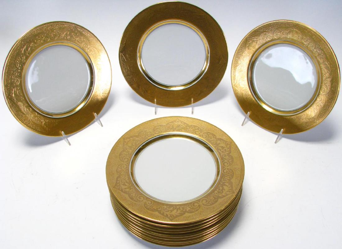 Set of 12 Stouffer Studios Gold Edge Dinner Plates: Set of 12 Stouffer Studios Gold Edge Dinner Plates, white porcelain plates with 1.75" of encrusted gold and floral decoration, round gold hallmark on back reads "Stouffer Fine China", 10.5" diameter