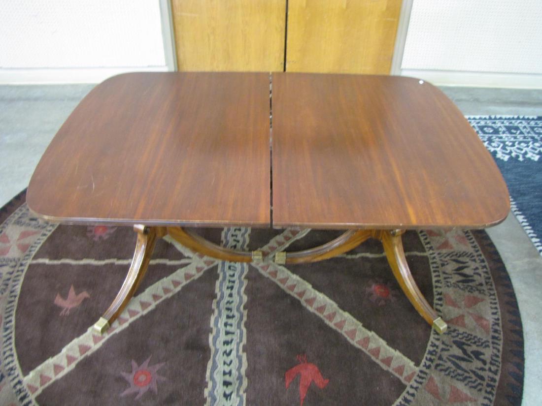 Duncan Phyfe Style Mahogany Table: A mahogany dining table, Duncan Phyfe style, with reeded columns on double pedestals, two 12" leaves, 63x42x30"h (without leaves)
