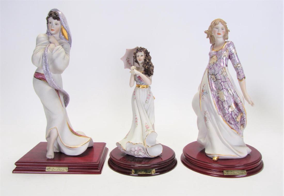 Three Vittorio Sabadine Porcelain Figures: Three Vittorio Sabadin Porcelain Figures, one depicting woman in flower dress holding parasol; one depicting woman with purple scarf; one depicting woman in purple and white dress; all marked "Vittori