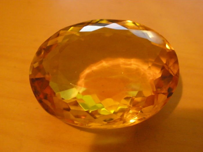 Citrine 63,60 ct.: sertificate number :н-3493,,Product Name topaz,,Shape/Cut-oval cut,,Color yellow gold,,Optic character DR,,Weight 63,60 ct.,Size 28 mm. x 23,00 mm. x 13.00 mm.
