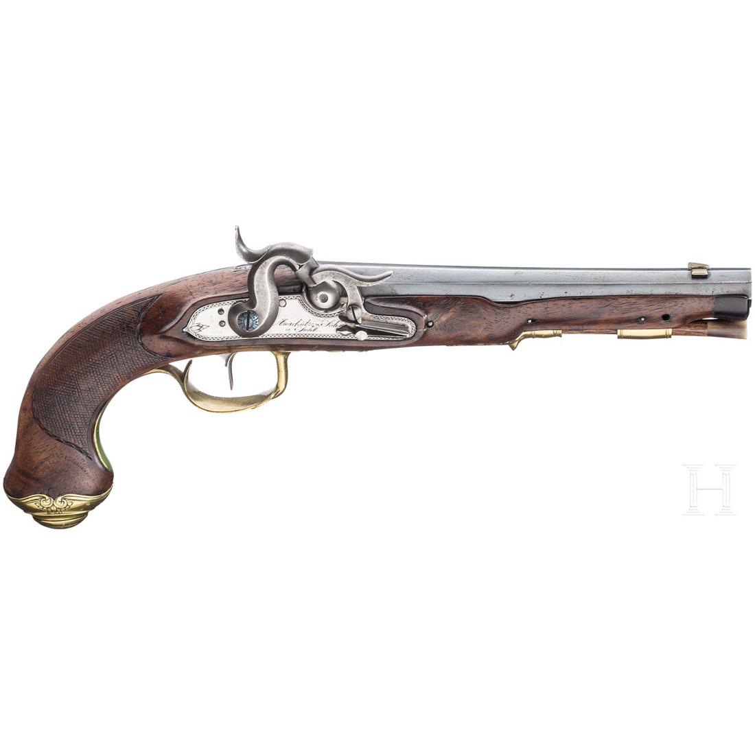 A percussion pistol, AnschÃ¼tz & Sons, Suhl, circa 1820: Glatter Achtkantlauf im Kaliber 12 mm mit eingeschobenem Neusilberkorn und eiserner Kimme. Aptiertes Perkussionsschloss mit zuklappbarem Distanzhalter, auf der gravierten Schlossplatte signiert "Ansch