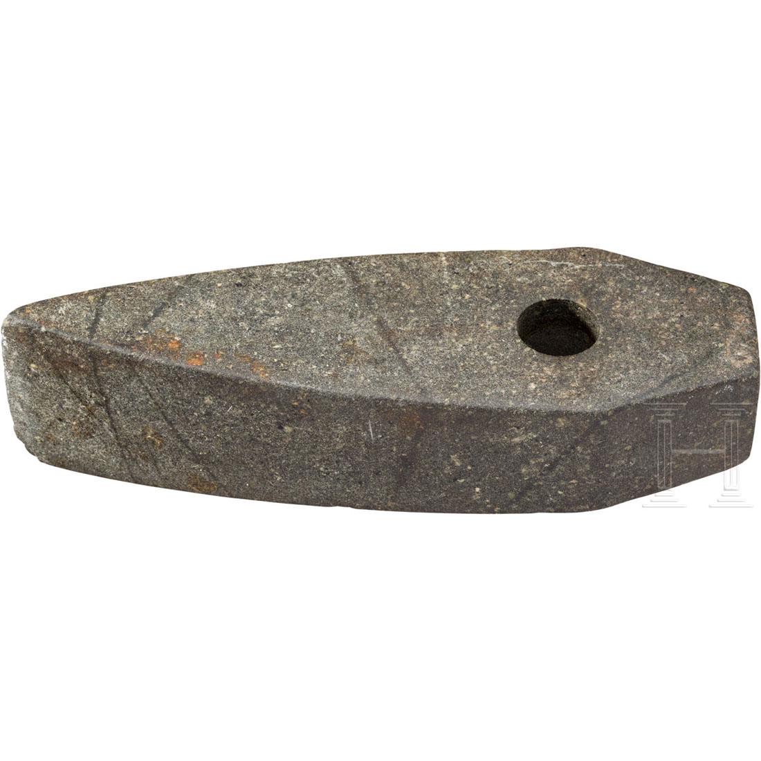 A Nordic Bronze Age stone axe, 1100 - 550 B.C.: A pentagonal stone axe of the Lausitzer-type with straight neck and reinforced shaft hole. The body becomes sligthly wider towards the minimally bumped edge. 2.5 cm long old chipping at the neck. Beau