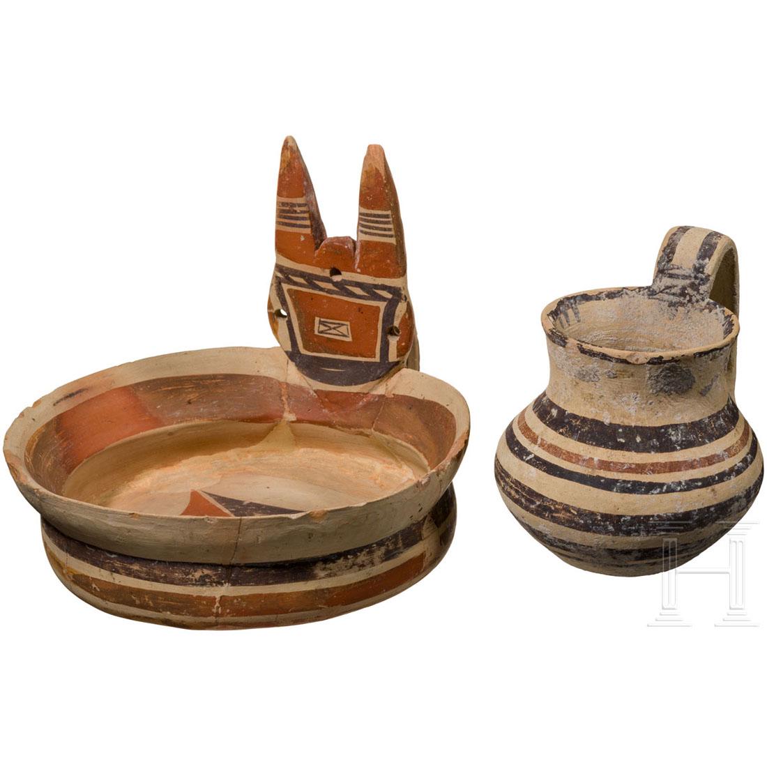 Two Daunian vessels: a small oinochoe and a kyathos,: A Daunian, subgeometrickyathos (probably Canosa, ca. 550 - 500 B.C.) from reddish body with beige, ochre and brown coating. Height 14 cm, diameter 17.3 cm. In addition a small bulbous oinochoe with da