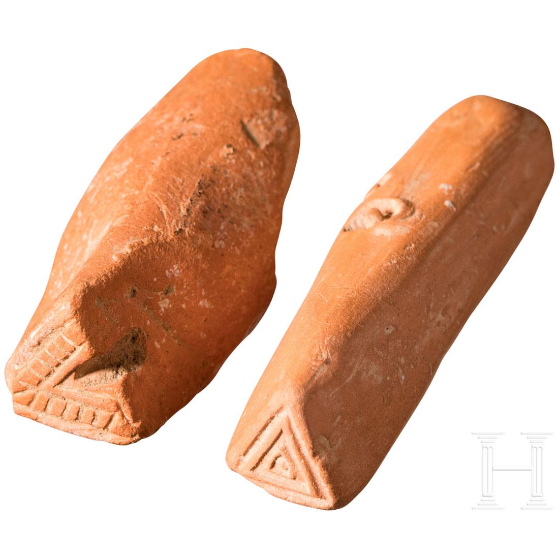 Two Roman clay stamps for ceramic decoration, 4th - 5th: Small red clay stamp with triangles. Marked by three circles on the stem. L. 4.3 cm. And a stamp of red clay with an open triangle (V-shaped). Bumped. L. 3.2 cm. Rare decoration tools from a pottery w