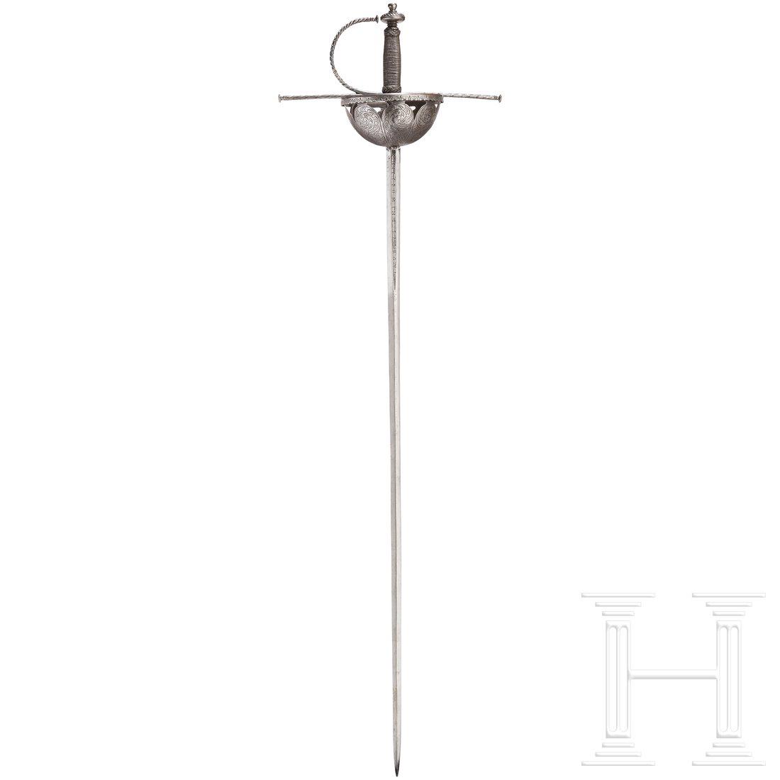 A Spanish cup-hilted rapier, 2nd half of the 17th: The double-edged thrusting blade of diamond section with a sturdy ricasso. Inscribed in the short fuller on both sides "FECIT IN TOLEDO" and "INTE DOMINE SPERAVI". The semi-circular cup divided into e