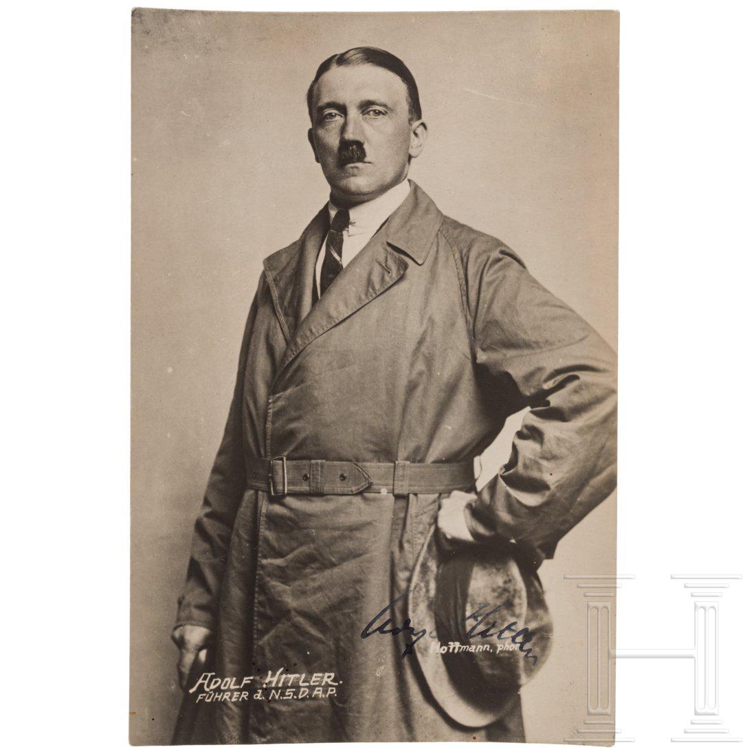 An early personally signed postcard of Hitler: Dreiviertelportrait, Anfang September 1923, Hitler mit Trenchcoat, Hut und Stock, betitelt "Adolf Hitler FÃ¼hrer der N.S.D.A.P." sowie "Hoffmann, phot.", darÃ¼ber eigenhÃ¤ndig in Tinte signiert 