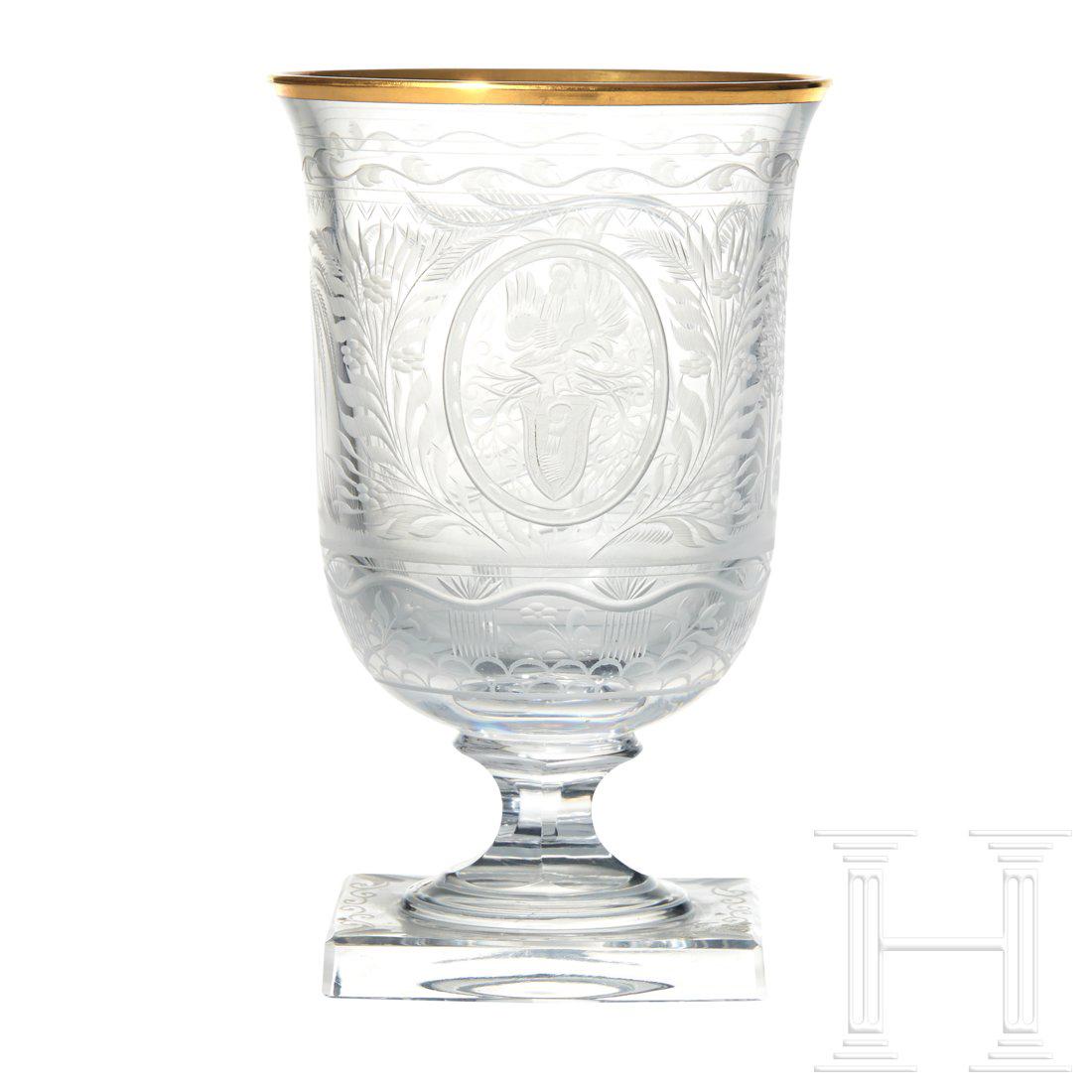Hermann Goring â€“ a Goblet from a Hunterâ€™s Table: Cut and faceted crystal glass with gold rim. On the viewing side an oriental prince lying in a palm grove and holding a roe deer fawn in his arms. The helmeted Goring family coat of arms set in a meda