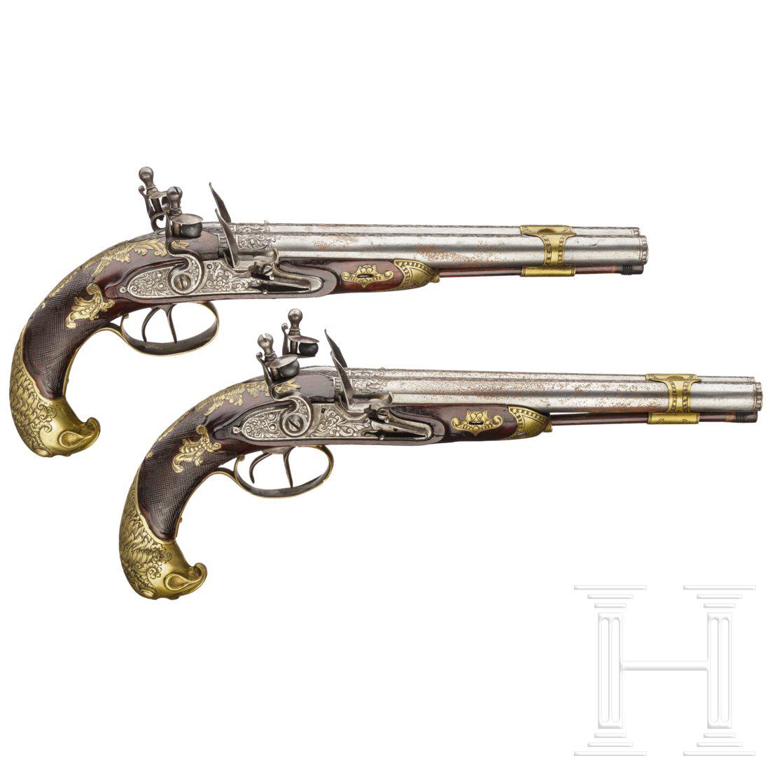 A pair of double-barrelled flintlock pistols, circa: Both pistols with single, smooth barrels in 14 mm calibre connected by an engraved barrel band, the muzzles finely engraved, the upper sides of the barrels decorated with bands of cut scrollwork, tang