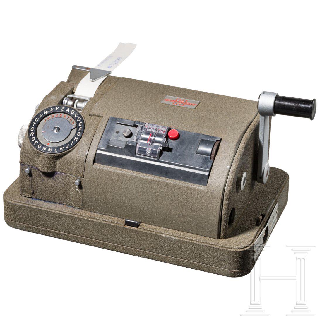 A cipher machine CX-52 or CX/RT: Mechanical rotor machine, manufactured from 1952 onwards by Crypto AG in Zug, Switzerland. The first model was the CX-52 with six pinwheels, followed by the CR/RT with six pinwheels and a tape reader.