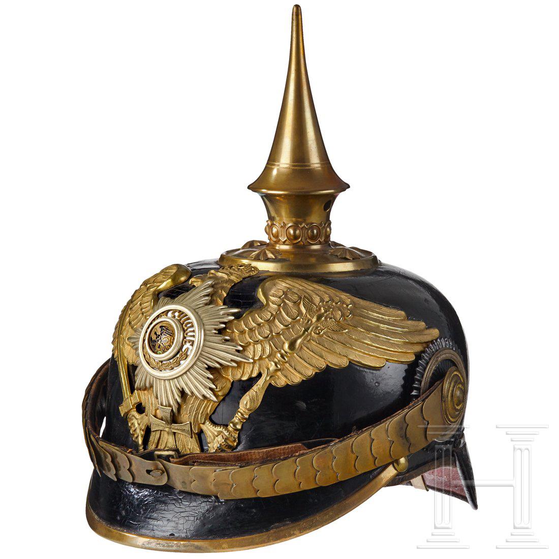A Prussian Spiked Helmet for Officers of the Infantry: Black leather: body, front visor with green underlay and rear visor with red underlay. Gilt officer Prussian eagle with centre enamel guard star on front plate attached with two screw posts with nut f
