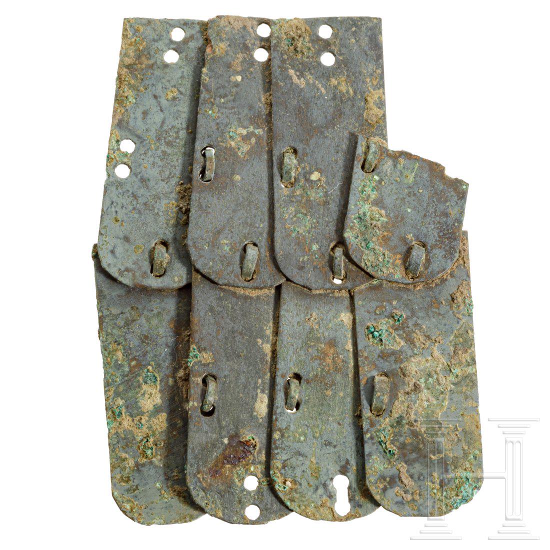 A fragment of a Roman lorica squamata, 1st - 3rd: Segment of a lorica squamata. The eight overlapping lamellas are connected by a bronze wire. One lamella is broken. Beautiful dark-green patina. Length 5.1 cm. Beautiful collector's specimen! Provenan