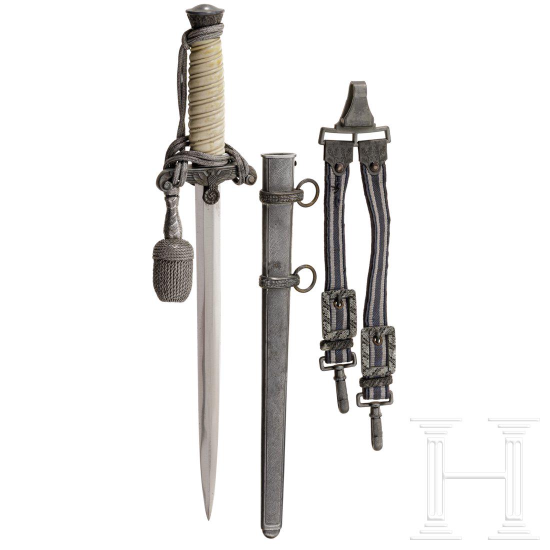 An army officer's dagger M 35: Klinge ohne Herstellerbezeichnung. Versilberter Knauf und Parierstange, weiÃŸer Kunststoffgriff, silbernes Portepee. Versilberte Eisenscheide. Dazu ein GehÃ¤nge der Luftwaffe. LÃ¤nge ca. 37 cm. 