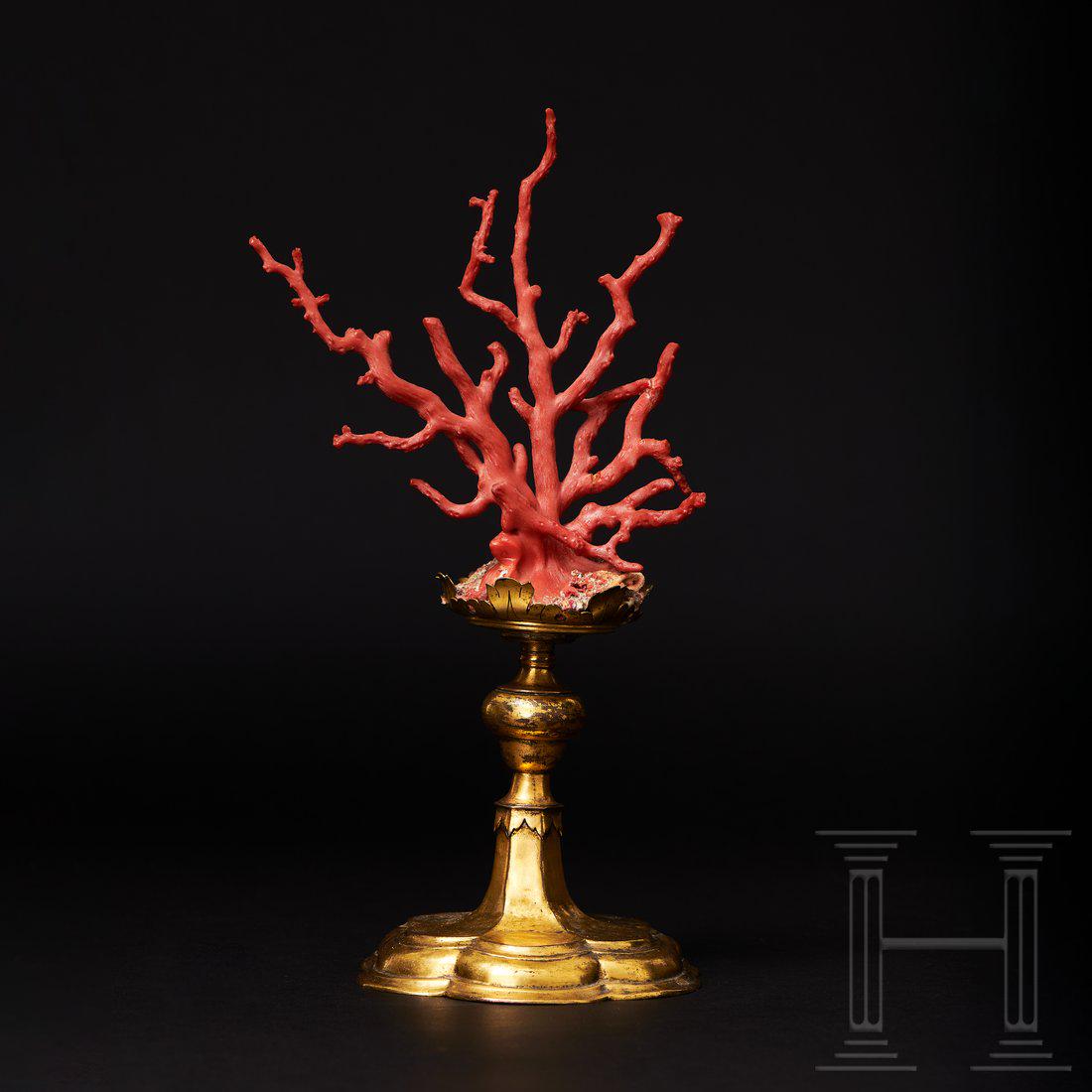 An Italian coral tree on a baroque stand, 17th century: Beautifully shaped, densely grown red coral with several stout branches. On a baroque stand of fire-gilt copper. The hexagonal, stepped base with a sturdy baluster shaft. Total height 34.5 cm.Conditio