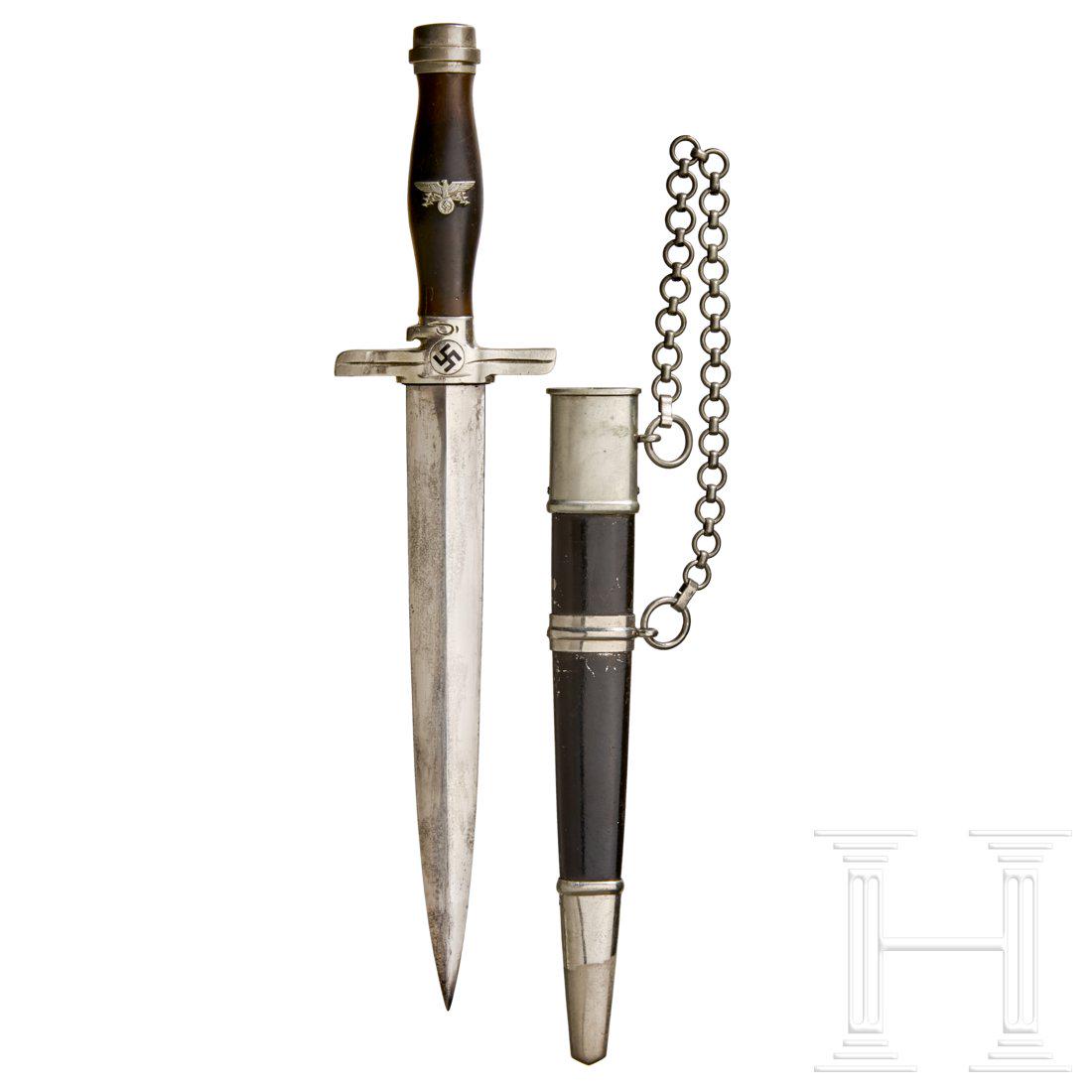 A Model 1939 Dagger for Leaders of the Postal: Maker Paul Weyersberg, Solingen, polished steel blade exhibits significant age marks with etched manufacturerâ€™s logo. Nickel cross-guard and pommel, underside of cross-guard stamped â€œDRP&