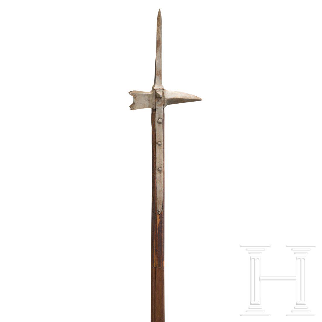 A German late Gothic war hammer, circa 1500: The slender spike of diamond section, the ridges offset. An illegible smith's mark stamped on one side. A sturdy, slightly curved, quadrangular beak, the hammer head on the opposite side ending in fou