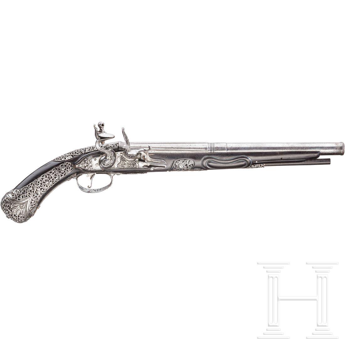 A chiselled flintlock pistol, Brescia, late 17th: Two-stage barrel, with longitudinal fullers at the breech, then round and smooth after a chiselled girdle, in 12 mm calibre with cannon muzzle. Flintlock with floral decoration chiselled in relief and