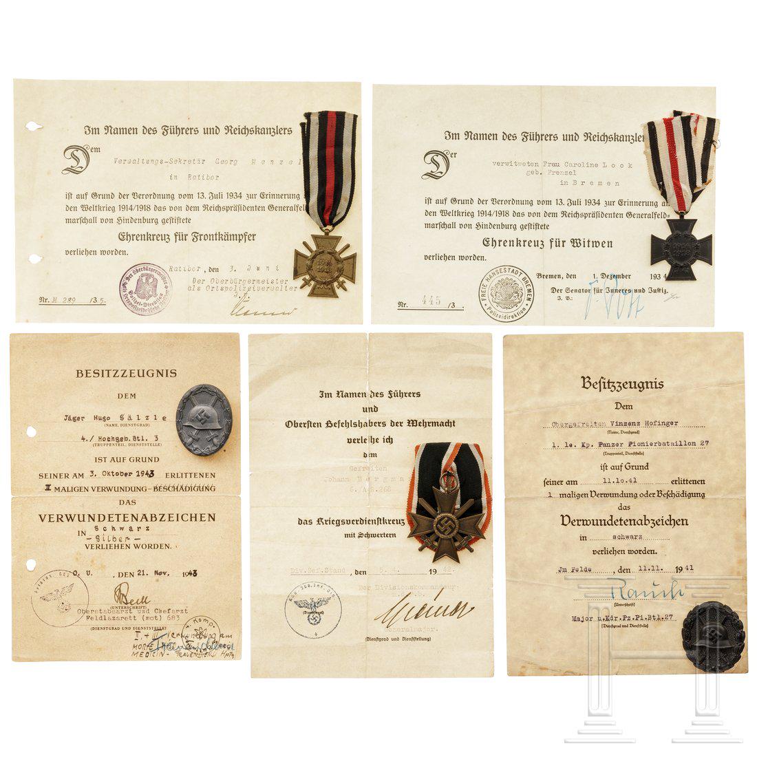 A group of five medals with award documents - a Wound: A group of five medals with award documents - a Wound Badge in black and one in silver, a War Merit Cross with swords, a Hindenburg Cross and a Cross for WidowsKonvolut Orden und Urkunden: ein Verwund