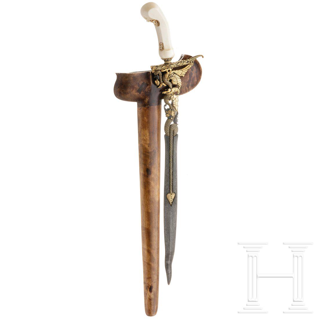 A Balinese keris, 20th century: A Balinese keris, 20th centuryGerade, am Ort leicht geflammte Klinge mit reich geschnittenem und durchbrochen gearbeitetem Ansatz. Mendak mit Besatz aus Schmucksteinen, leicht beschnitzter Griff aus E