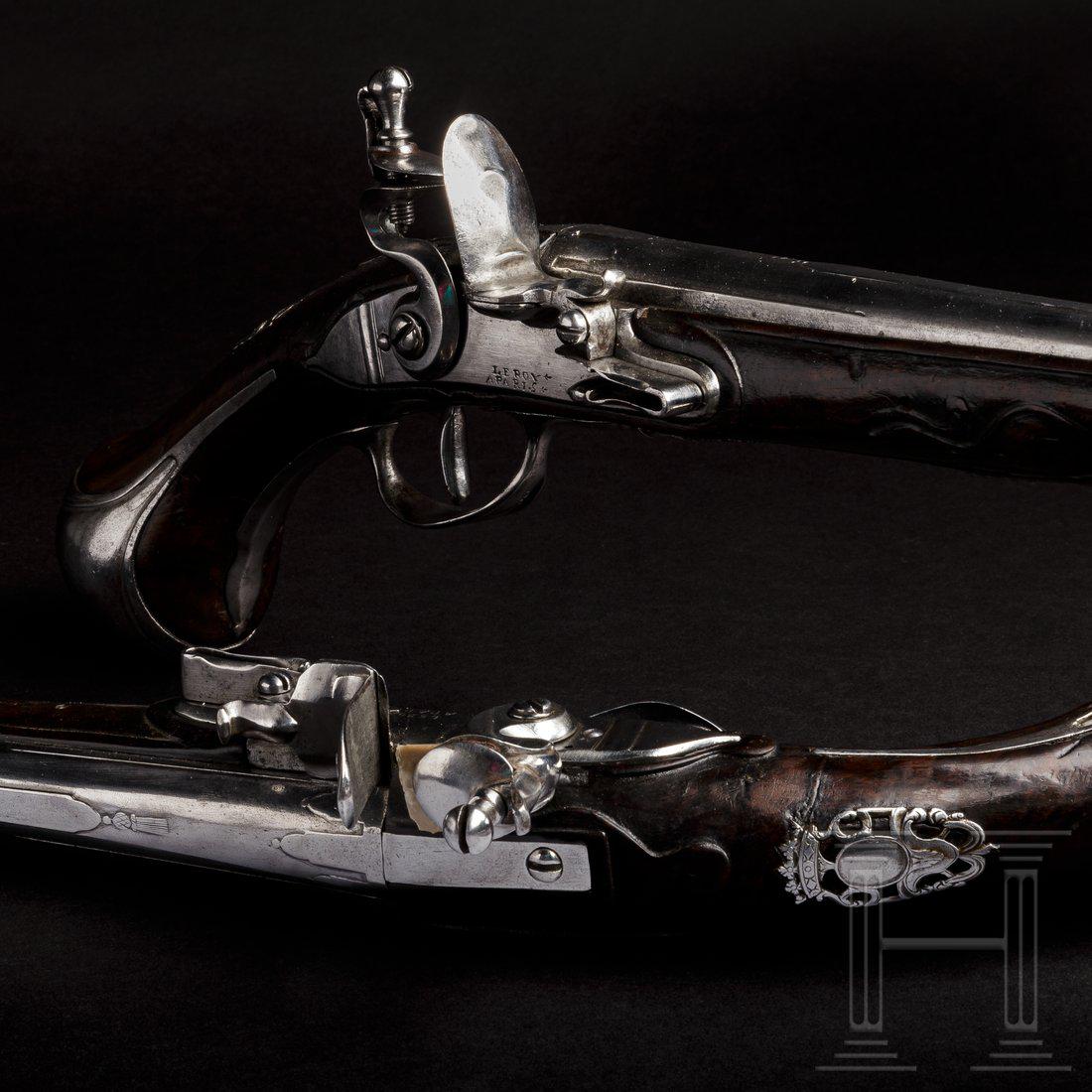 A pair of flintlock cavalry pistols by LeRoy Ã Paris,: A pair of flintlock cavalry pistols by LeRoy Ã Paris, circa 1710/20Round barrels with offset midribs, smooth bores in 15 mm calibre. Surface-mounted, brass front sights. The flat lock plates both s