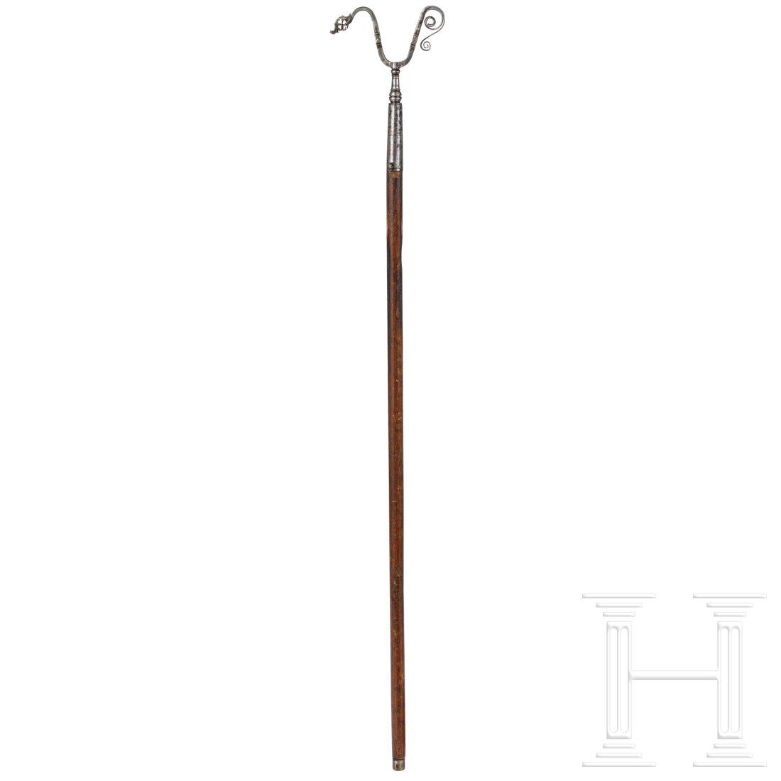 A German musket rest with match-holder, first half of: A German musket rest with match-holder, first half of the 17th centuryFein geschmiedete eiserne Gabel. Ein Ende in einen Luntenhalter mit Stellschraube auslaufend, das andere Voluten. Einseitig zwei A