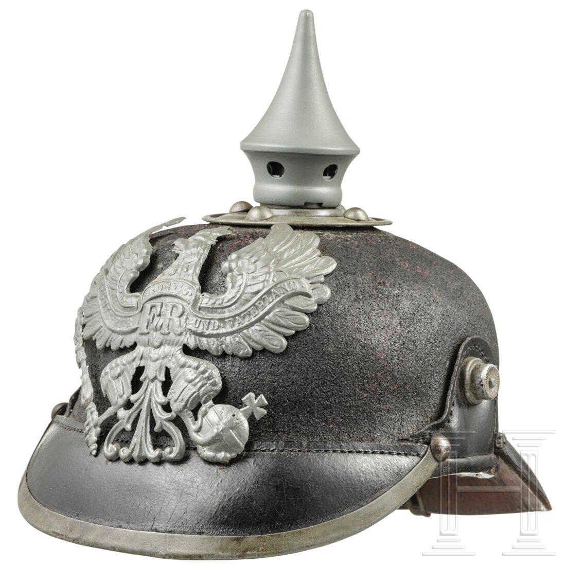 A helmet M 1896 for enlisted men of the infantry with: A helmet M 1896 for enlisted men of the infantry with helmet coverKammerstück. Schwarz lackierter Lederkorpus (Dellen, raue Oberfläche), Beschläge aus weißem Metall. Adleremblem (g
