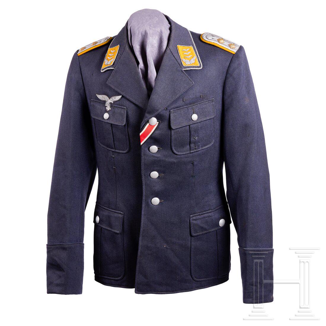 A Tunic for an Officer of the Luftwaffe: A Tunic for an Officer of the LuftwaffeBlue-grey, very fine quality tricot wool, privately tailored with four pockets, an open collar piped in silver twist cord and four button front with silver pebbl