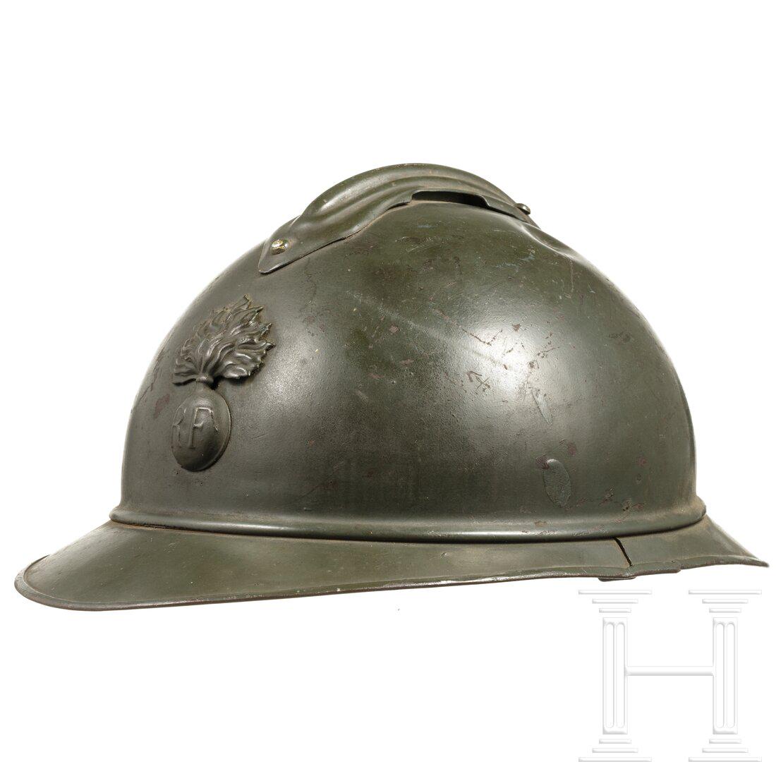 A steel helmet M 15 (Adrian) for enlisted men of the: A steel helmet M 15 (Adrian) for enlisted men of the infantry Stahl, blaugrau lackiert, darüber in der Tragezeit olivgrün lackiert (etwas berieben, kleine Dellen), angenieteter Kamm, stirnse