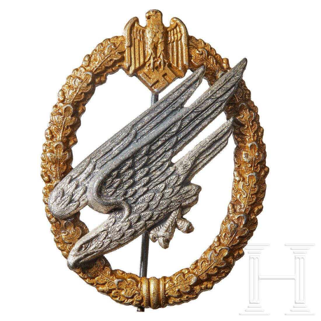 An Army Paratrooper Badge: An Army Paratrooper Badge Unmarked Juncker, die struck zinc, gilt wreath with riveted eagle with vertical pinback, dimensions approx. 42 x 56 mm. Collector applied a clear finish.