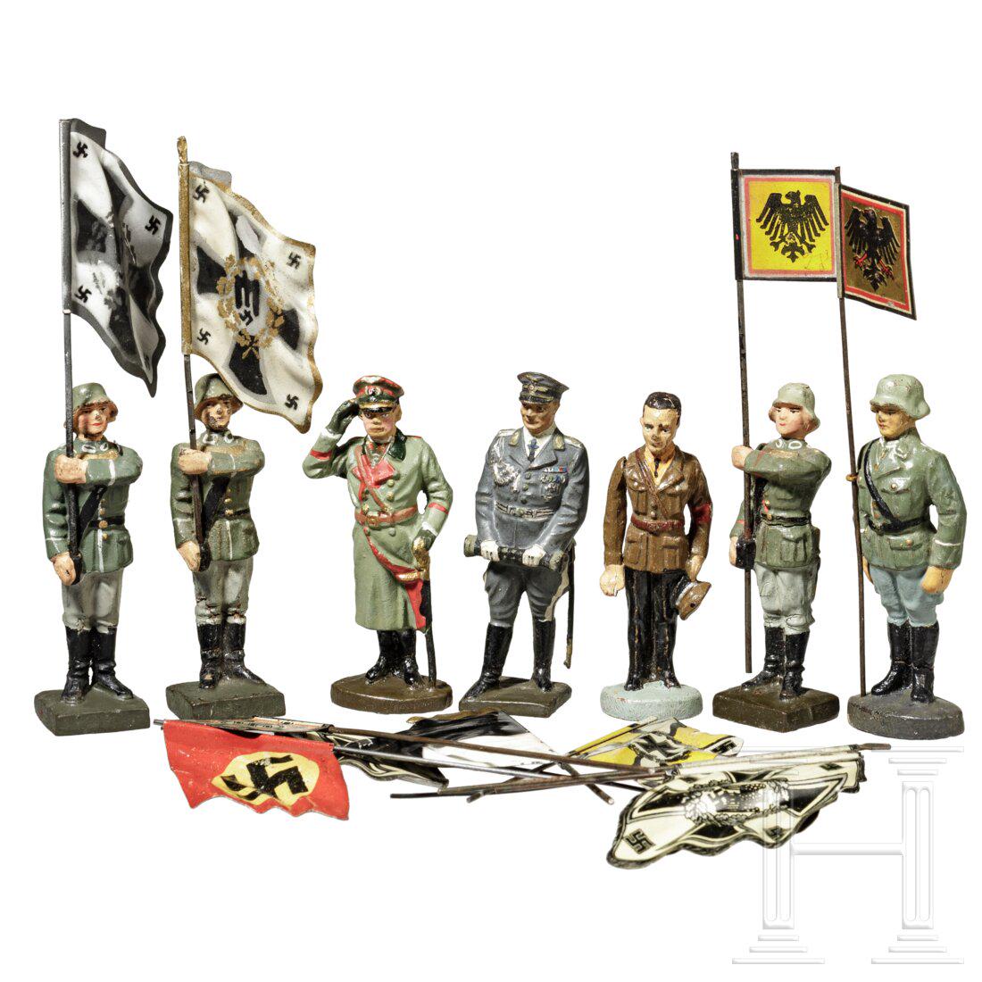 A group with Lineol and Hausser Elastolin flag and standard bearers, Goebbels, Goering and eight: A group with Lineol and Hausser Elastolin flag and standard bearers, Goebbels, Goering and eight flags Elastolin/Lineol, Masse-Blechausführung, 30er Jahre, 7-cm-Serie. Ein Konvolut mit sieben Fig