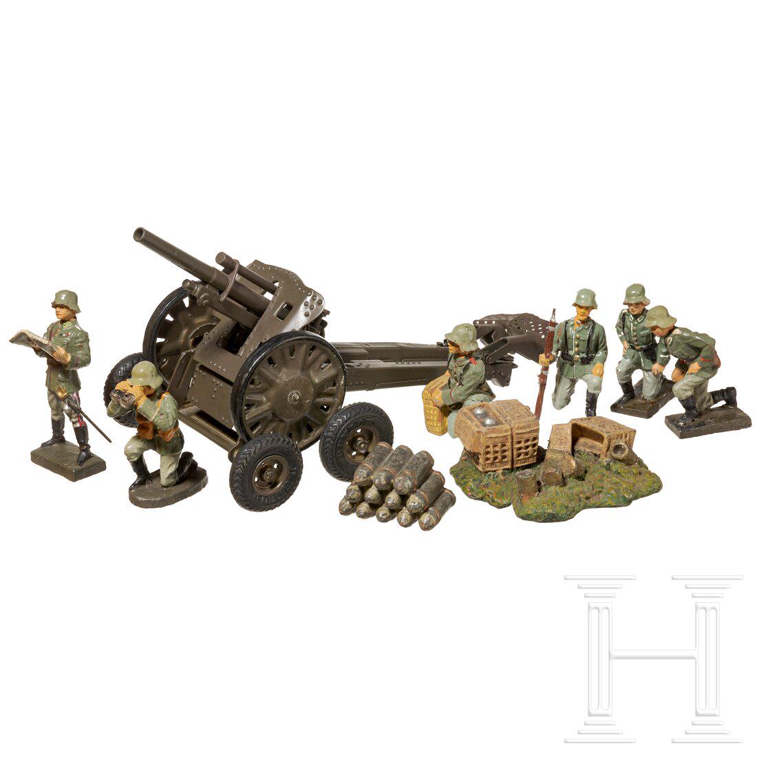 A Lineol Light Field Howitzer 813 with Homann-Webau jack-up truck and eight cannon crew soldiers: A Lineol Light Field Howitzer 813 with Homann-Webau jack-up truck and eight cannon crew soldiers with an Elastolin shell pile groupElastolin/Lineol/Homann-Webau, Blech-Masseausführung, 7 cm-Serie