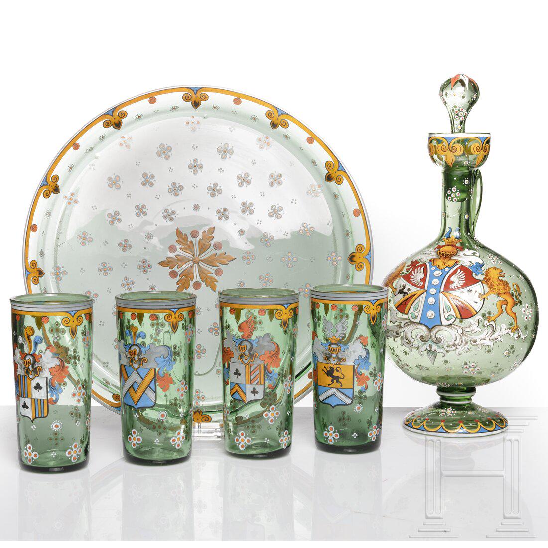 A Bohemian green glass six-piece drinking service, circa 1880: A Bohemian green glass six-piece drinking service, circa 1880Polychrome enamel painting. Diameter 30 cm, height 32 and 13 cm.Condition: I - II