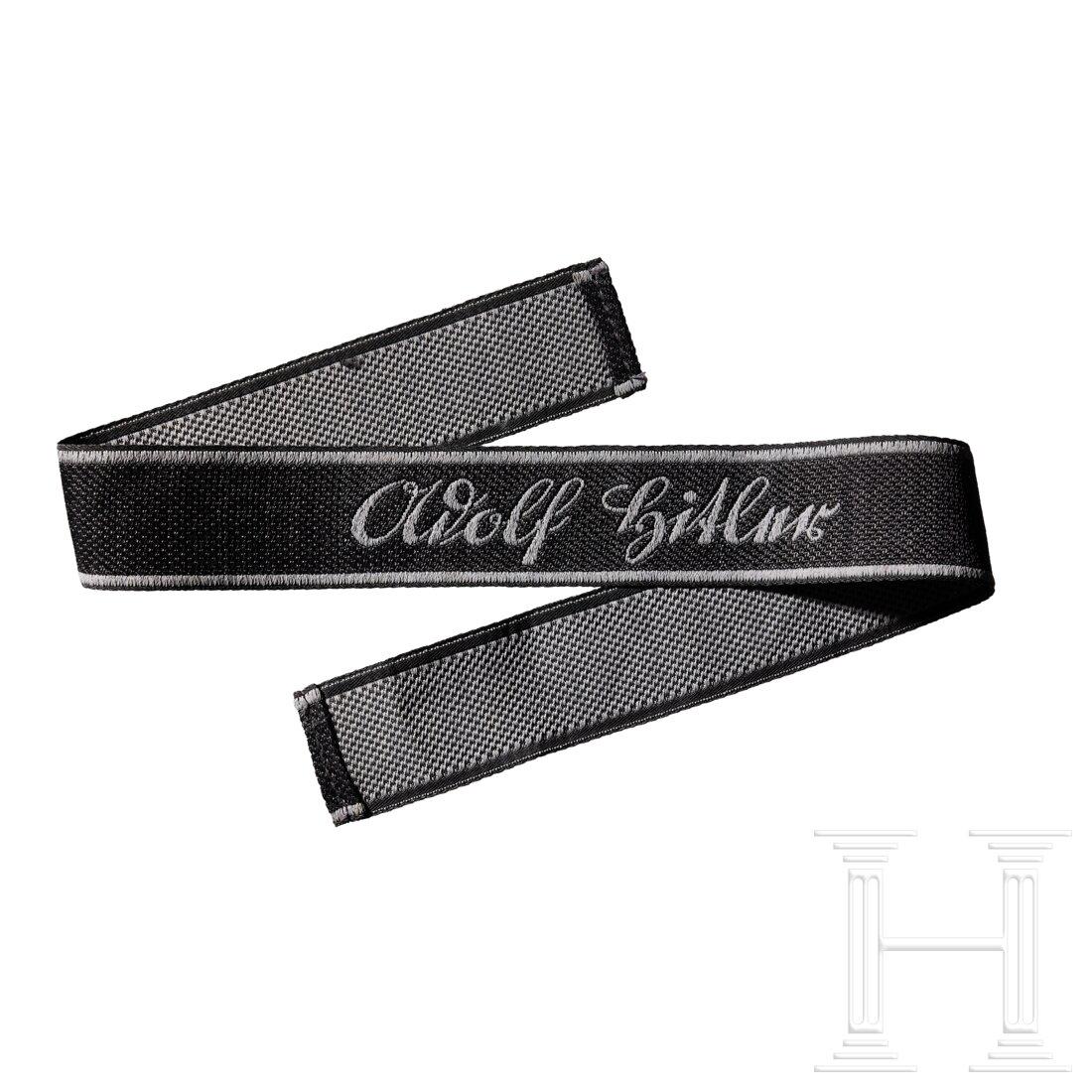 A cuff title â€œAdolf Hitlerâ€ for enlisted personnel: A cuff title â€œAdolf Hitler” for enlisted personnelBlack band with silver-grey thread borders, machine-woven name in silver-grey thread, finished ends. Length ca. 50 cm.
